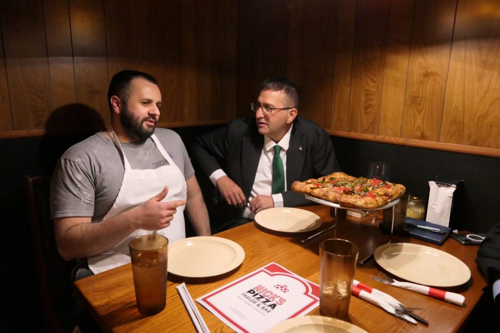 Governor Matt Meyer meeting with a small business owner.